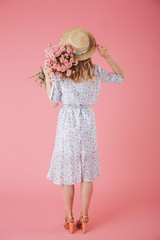 Full length back view portrait of a pretty young woman
