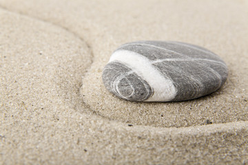Fototapeta na wymiar stones on sand for relaxation as background