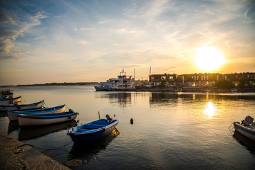 Fototapeta na wymiar Old boats on Nesebar harbour, Bulgaria. Sunset photo of boats in Black sea