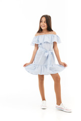 Full length image of Playful young brunette girl in dress