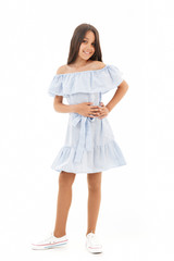 Full length image of Smiling young brunette girl in dress