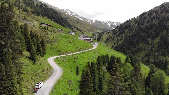 Hiking into a small Mountain Village in a Valley - Aerial Flight