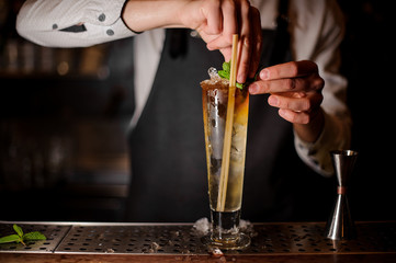 Barman adding the mint leaves to the summer cocktail