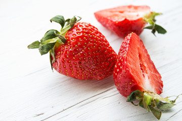Berries of strawberries on a light wooden background. Copy space.