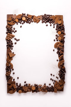 Chocolate frame / Creative concept photo of frame made of chocolate on white background.