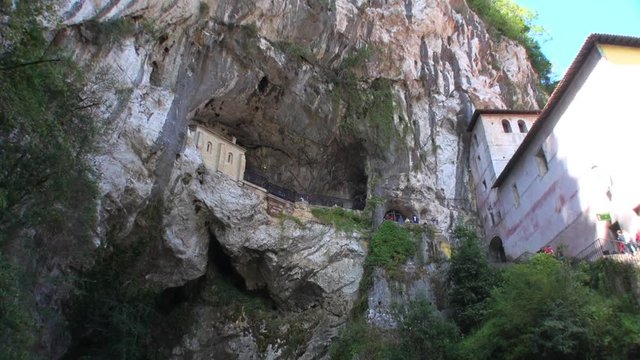 Pan Upward: River under Cave of Covadonga Cathedral