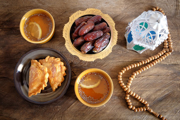 Dates  fruit, rosary, tea on wooden background. The Muslim feast of the holy month of Ramadan