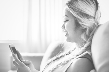 Smiling woman using a smartphone