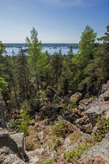 Lake, lush forest and rocky hill viewed from the rocky hilltop of Pirunvuori (
