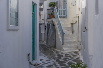 Mykonos, Greece whitewashed alleys. Traditional dotted narrow alleys with painted doors and white stairs at Mykonos Town (Chora). © bestravelvideo