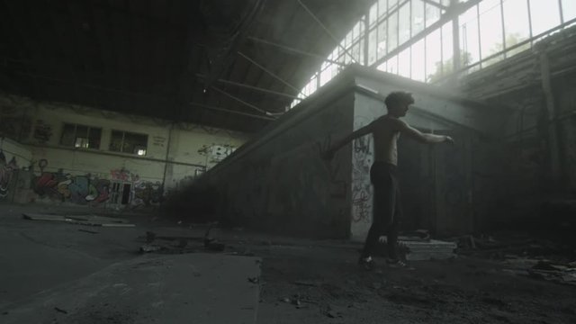 Backflip Trick with akick in dirty abondoned factroy 