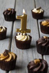 Number 1 celebration birthday cupcakes on a wooden background