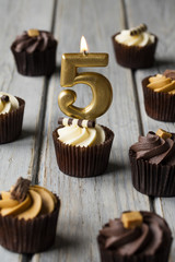 Number 5 celebration birthday cupcakes on a wooden background