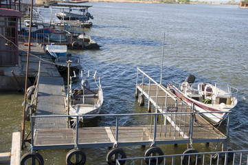 Old pier with motor boats.
