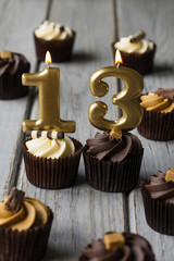 Number 13 celebration birthday cupcakes on a wooden background