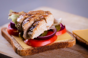 Fresh homemade grilled chicken sandwich on a wood