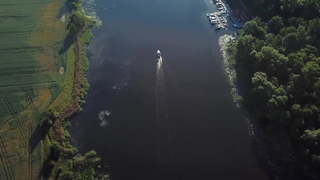 Aerial: boat on the river at dawn