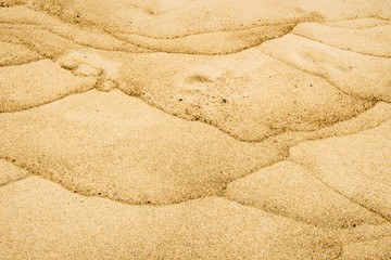 Sand of a beach with wave patterns