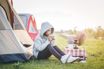 Young woman camping on the Big mountain , Drink a hot coffee