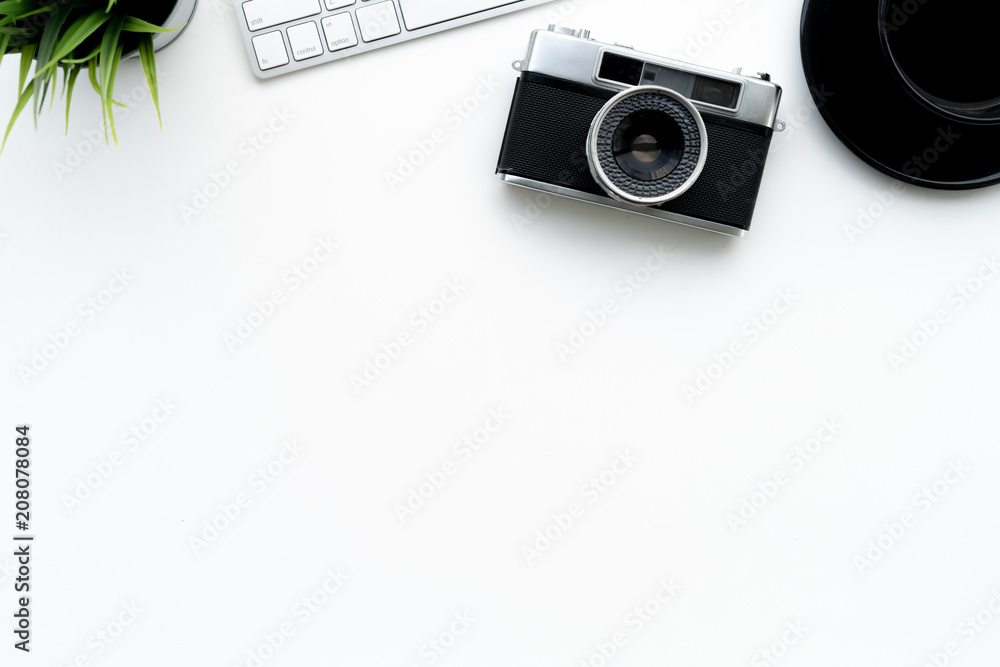 Poster flat lay of top view modern white desk work table with computer laptop ,retro film camera and statio