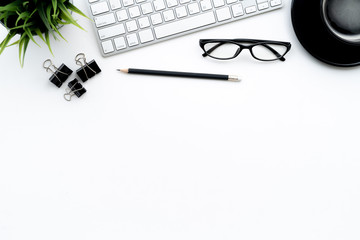 Flat lay of top view modern white desk work table with computer laptop and stationary in home office includes copyspace for add text or graphic