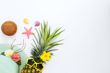 Hipster pineapple fashion with tropical fruit, sea shells and starfish. Summer vacation background concept. Top view, flat lay