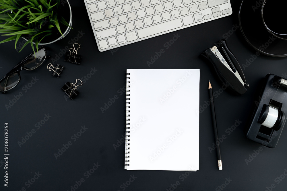 Poster flat lay of top view modern black desk work table with computer laptop and stationary in home office