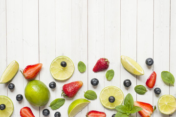 Fresh berries of citrus lime mint blueberries strawberry on a light background. Copy space for text