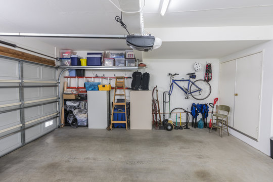 Organized clean suburban residential two car garage with tools, file cabinets and sports equipment.  