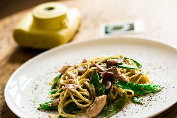Polaroid, photo camera. Macaroni on a dark background. concept photography of a dish overlooking. camera and dish