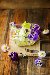 Obraz na płótnie Canvas Spring salad with radishes, edible flower and sauce, selective focus