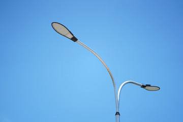 LED street lights on the road with blue sky background.