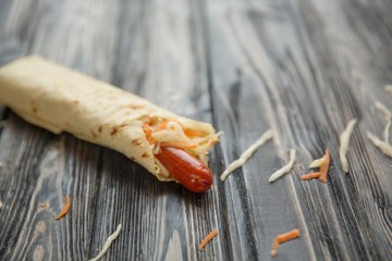 sausages with salad in pita bread on wooden background.photo with copy space
