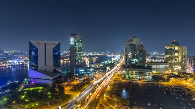Dubai creek landscape night timelapse with boats and ship near waterfront