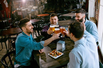 Men Drinking Beer In Pub