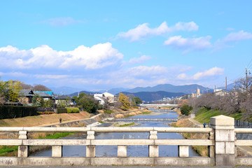 Fototapeta na wymiar Japanese countryside landscape seen from the old bridge, Kamo-gawa river, Kyoto, Japan