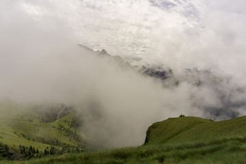 Naklejka na ściany i meble A cloudy beautiful landscape of the Dolomites in June. Italy.