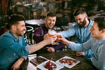 Men Drinking Beer In Pub