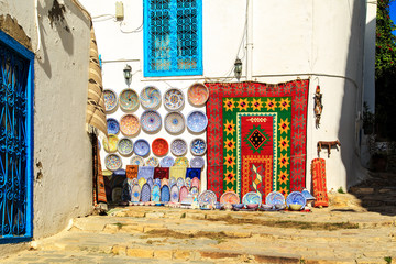 Souvenir earthenware and carpets in tunisian market.