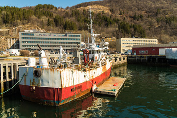 Fototapeta na wymiar A rusty ship at the port of Narvik, Norway