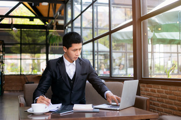 Business man working at office with laptop and documents on his desk, consultant lawyer concept