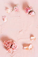 Tender textured pink background with dried roses