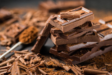 Pile of broken dark chocolate on table