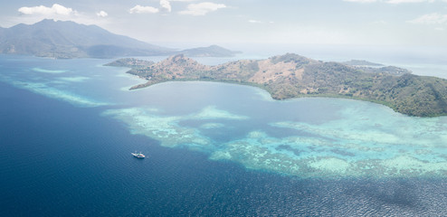 Aerial View of Ship, Coral Reef, and Islands Near Flores