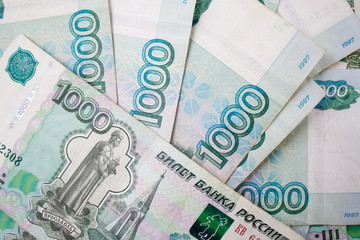 business, finance, saving, banking concept - close up bundle of money Russian Banknotes thousand rubles