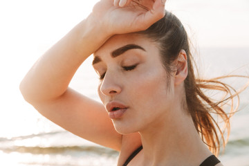 Close up portrait of an exhausted young sportswoman