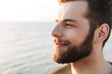 Close up of happy young sport man looking away