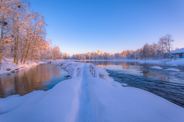 Fototapeta na wymiar Winter landscape from Pajakka river. Kuhmo, Finland.