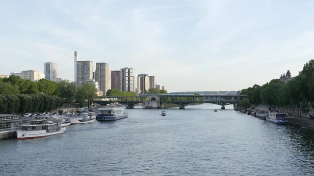 Paris river Seine and high business buildings with Metro train goes over the bridge in evening