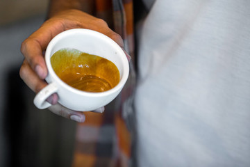 Coffee workshop barista make a Coffee latte art  Selective focus white cup.color vintage style.